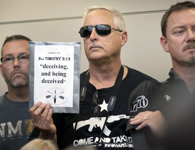 Bob Welch holds a sign at a public hearing about the Jade Helm 15 military training exercise in Bastrop, Texas, on April 27.