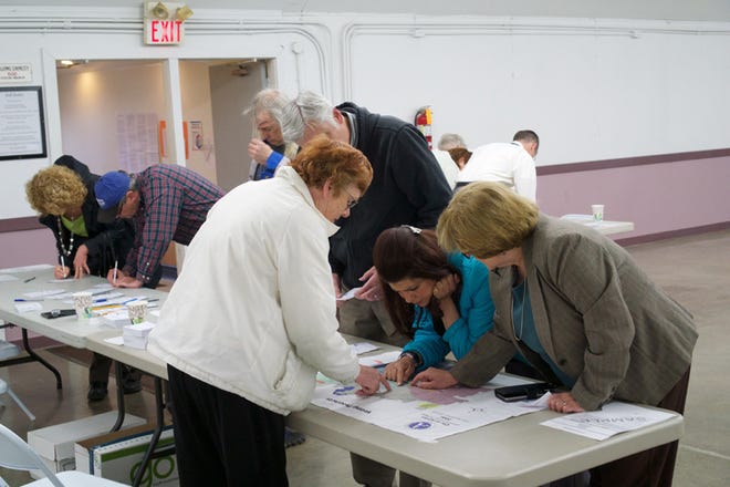 People arrive this morning to vote at the Lenawee County Fair and Event Grounds on the state’s road-funding proposal and the Adrian District Library’s millage proposal.