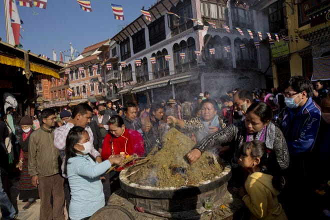 NEPALESE BUDDHISTS light incense sticks at the Boudhanath Stupa during Buddha Jayanti, or Buddha Purnima festival in Kathmandu, Nepal, on Monday. Hundreds of people have visited Buddhist shrines and monasteries in Nepal's quake-wracked Kathmandu on Buddha Purnima to pray for the country and the people who suffered during April 25 earthquake.