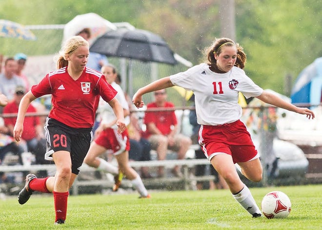Pekin’s Tayler Scally passes the ball while Metamora’s Laura Wipfler defends during their game Tuesday in Pekin.