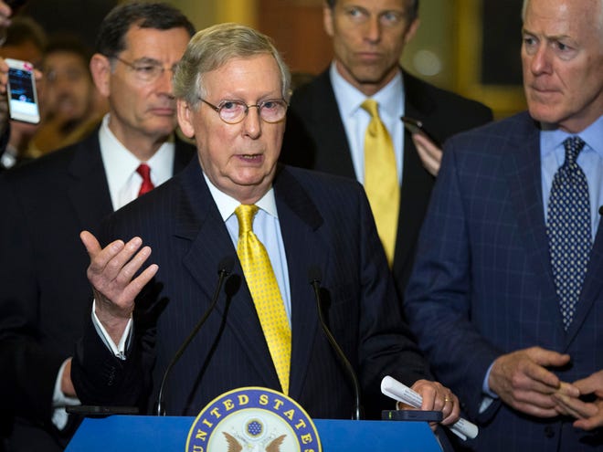 Senate Majority Leader Sen. Mitch McConnell of Ky., accompanied by, from left, Sen. John Barrasso, R-Wyo., Sen. John Thune, R-S.D., and Senate Majority Whip John Cornyn of Texas, speaks during a news conference on Capitol Hill in Washington on Tuesday after a policy luncheon.