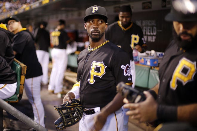 Pirates' Andrew McCutchen, center, prepares to take the field during a baseball game against the Reds in Pittsburgh on Tuesday. The Reds won 7-1.