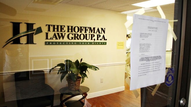 Consumer Financial Protection Bureau and Florida Office of the Attorney General paperwork is taped to the front door of the Hoffmnan Law Group, P.A. offices in North Palm Beach on July 16, 2014. (Richard Graulich/The Palm Beach Post)
