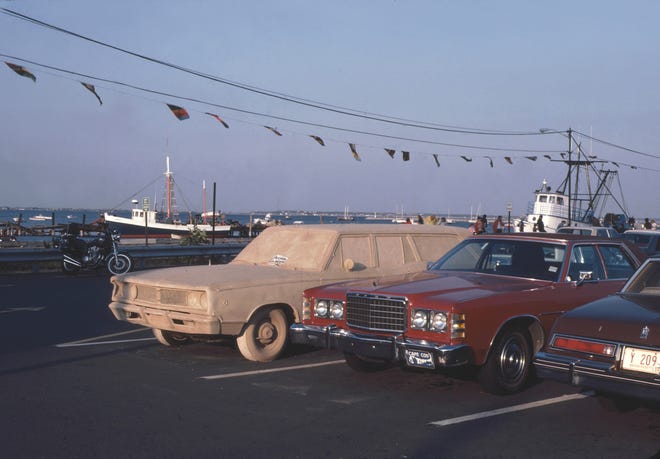 "Just Visiting," a sand-covered car Jay Critchley set up in the MacMillan Wharf parking lot in Provincetown in 1981. COURTESY OF JAY CRITCHLEY