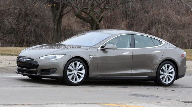 In a photo from Tuesday, April 7, 2015 in Detroit, a Tesla Model S 70D is seen during a test drive. Electric car maker Tesla Motors is seeking mainstream luxury buyers by adding all-wheel-drive and more range and power to the base version of its only model. The added features for the base Model S come with about a 7 percent price increase to $75,000. Starting Wednesday, Tesla will stop selling the old base Model S called the 60 and replace it with the 70-D. The new car can go 240 miles per charge and from zero to 60 in 5.2 seconds. (AP Photo/Carlos Osorio)