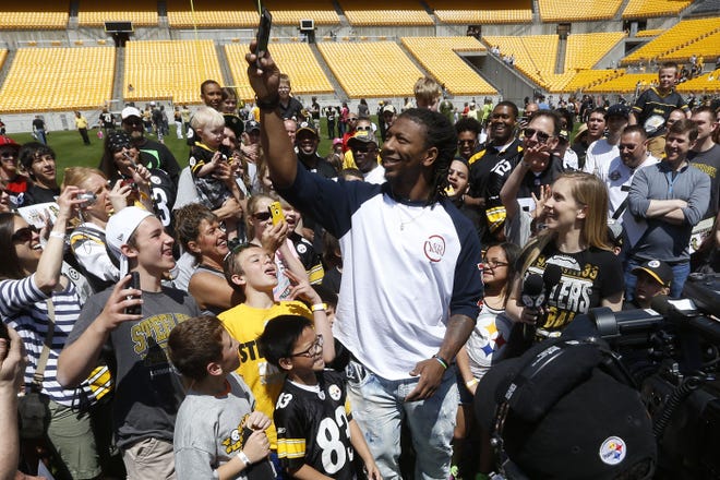 Steelers first round draft pick Bud Dupree, center, a linebacker out of Kentucky, takes pictures of the fans gathered around him at Fan Blitz, a promotional event put on by the Steelers at Heinz Field on May 2.