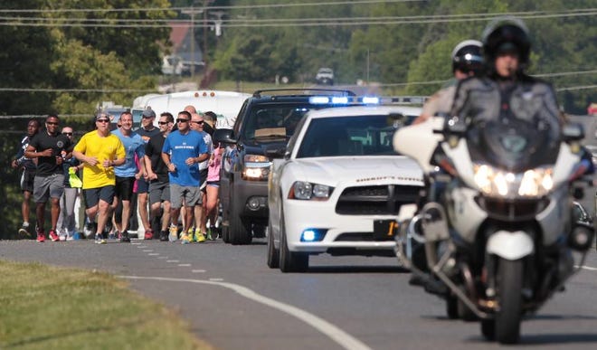 The 2015 Law Enforcement Torch Run for Special Olympics North Carolina makes its way along West Franklin Boulevard near Myrtle School Road in Gastonia on Friday morning. The torch, carried by Special Olympics athletes, will make its way to Raleigh at the end of May.