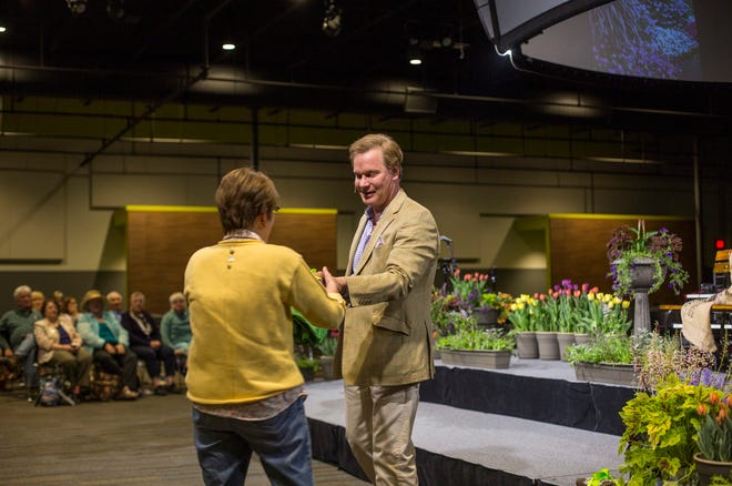 P. Allen Smith gives a prize to a member of the audience after they answered a question on Friday, May 8, 2015 at Engedi Church. Emily Brouwer/Sentinel Staff