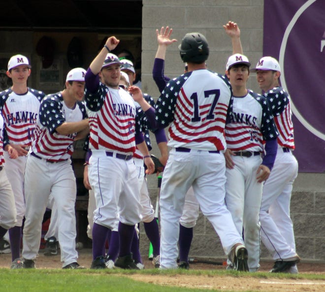 Marshwood High School's Jake Lebel (17) is congratulated by teammates after hitting a solo home run during the first inning of Saturday's Western Maine Class A baseball game against Westbrook in South Berwick.
John Doyle/Fosters.com