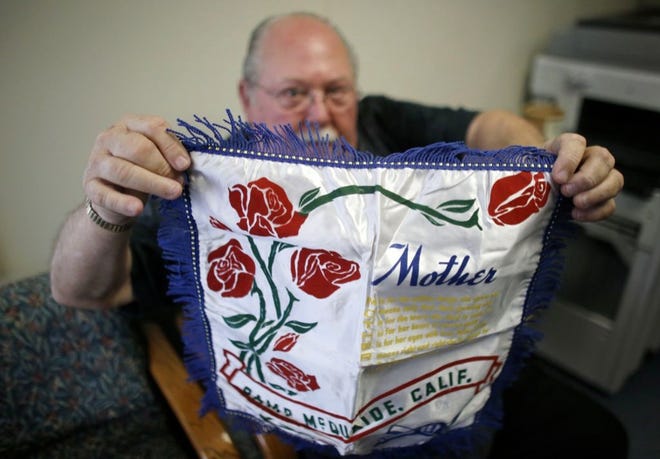 DON LAMOUREUX displays a World War II-era pillow sham at a senior center in Millville, Mass., which his son purchased from an online auction site. Dominic O'Gara had mailed the elaborate pillow sham from his U.S. Army base in California to his mother in Millville in 1942.