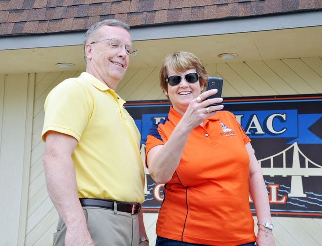 Pontiac Mayor Robert Russell poses with Pam Lyons while taking a selfie to highlight the “Selfie with the Mayor” tourism campaign.