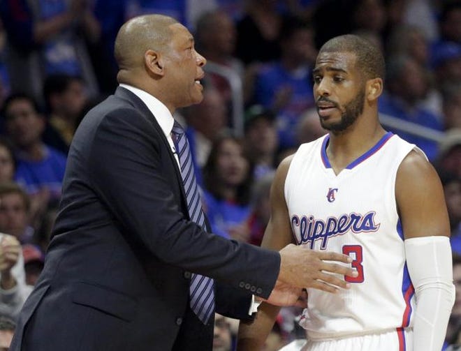 Los Angeles Clippers head coach Doc Rivers, talks with guard Chris Paul during the first half of Game 3 in a second-round NBA basketball playoff series against the Houston Rockets in Los Angeles, Friday, May 8, 2015.