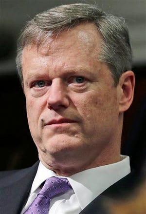 FILE - In this March 4, 2015, file photo, Massachusetts Gov. Charlie Baker listens to Kristen Lepore, secretary of administration and finance, during the unveiling of his 2016 budget proposal during a news conference at the Statehouse in Boston. Baker's first 100 days in office was marked by an onslaught of winter storms that staggered the public transportation system, and spending cuts to combat an expectedly large budget deficit. (AP Photo/Charles Krupa, File)