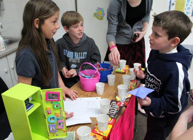 St. Mary’s School fourth-graders Carolyn Ladd and Luke Meredith, left, created a business called Spic and Span for the Spring Lake school’s Market Day. The daylong event gave students firsthand experience in the world of business. Krystle Wagner/Tribune Photo