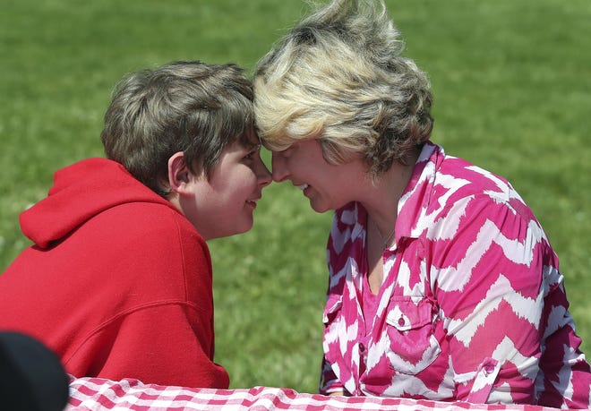 James Dahl, 12, continues the long road to recovery after surgery in December 2013 to remove half of his brain — a risky strategy to halt constant seizures that threatened his life. Mother and son shared a silent moment during an afternoon of kite flying and play at Awbrey Park Elementary School.  (Paul Carter/The Register-Guard)