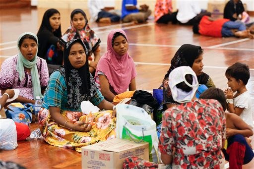 Illegal immigrants from Myanmar rest at a temporary immigration detention center in Langkawi, Malaysia Tuesday, May 12, 2015. About 1,600 Rohingya and Bangladeshi refugees have landed in Malaysia and Indonesia in the past day, apparently after human traffickers abandoned their virtual floating prison ships and left the passengers to fend for themselves, officials said Monday. (AP Photo/Vincent Thian)
