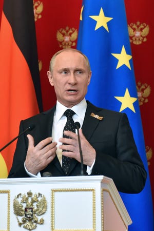 Russian President Vladimir Putin speaks at a joint news conference with German Chancellor Angela Merkel in the Kremlin in Moscow, Russia, on May 10. He may meet with U.S. Secretary of State John Kerry on Tuesday in the Black Sea resort of Sochi.