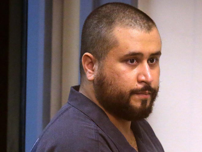 George Zimmerman, acquitted in the high-profile killing of unarmed black teenager Trayvon Martin, listens in court Nov. 19, 2013, in Sanford, during his hearing on charges including aggravated assault stemming from a fight with his girlfriend.