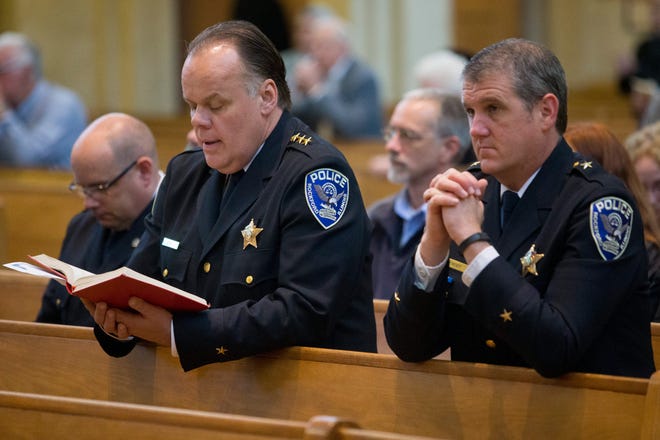 Rockford Police Chief Chet Epperson (left) and Assistant Deputy Chief Pat Hoey kneel Monday, May 11, 2015, during a Blue Mass at the Cathedral of St. Peter in Rockford. MAX GERSH/RRSTAR.COM