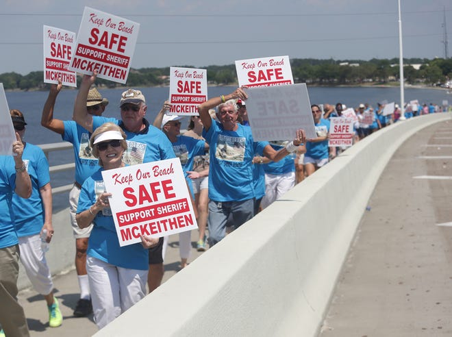 Over 100 locals march across the Hathaway Bridge in support of Sheriff McKeithen and Spring Break reform, organized by the Citizens For a New PCB on Sunday.