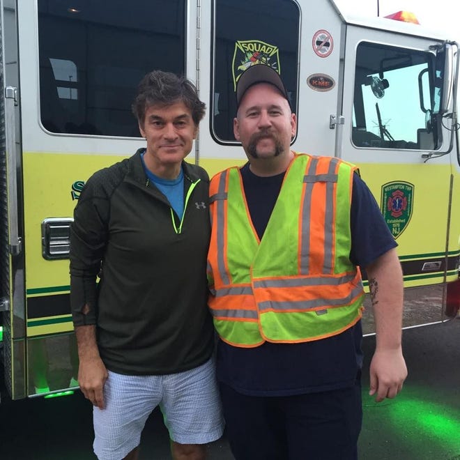 Firefighter/EMT Vincent Knott appears with Dr. Oz following an accident Saturday night on the New Jersey Turnpike.