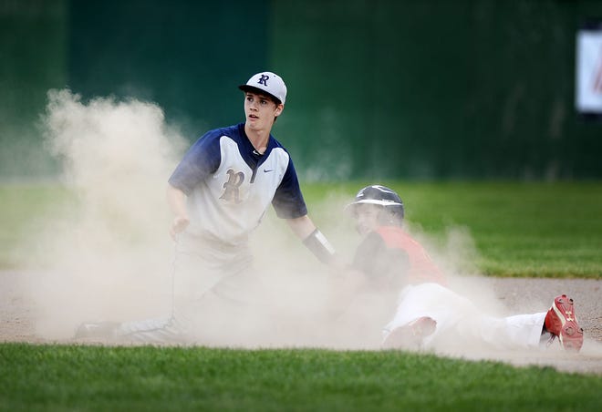Rochester's Hunter Valent and North Catholic's Daniel Lynch look up from a cloud of dust at second base during Tuesday's WPIAL playoff game at Chippewa Park. Lynch was out.