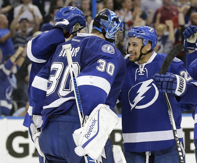 Tampa Bay Lightning goalie Ben Bishop (30) celebrates with right wing J.T. Brown after the team defeated the Montreal Canadiens 4-1 during Game 6 of their Eastern Conference semifinals playoff series in Tampa, Fla.