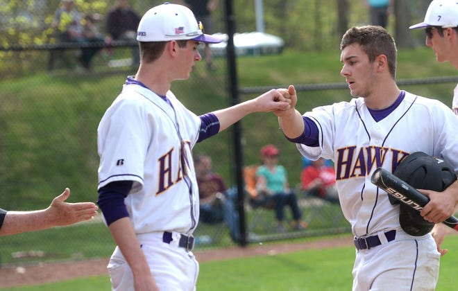 Marshwood High School's Zach Hodges, right, gets congratulated by teammates after he scored during Tuesday's Western Maine Class A baseball game against South Portland. The Hawks won 11-1.