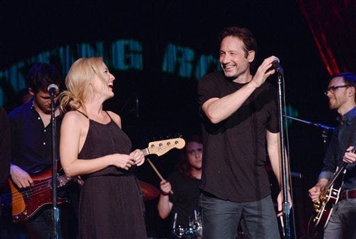David Duchovny is joined by actress Gillian Anderson during his performance at The Cutting Room, in support of the release of his debut album "Hell Or Highwater", on Tuesday, May 12, 2015, in New York. (Photo by Evan Agostini/Invision/AP)