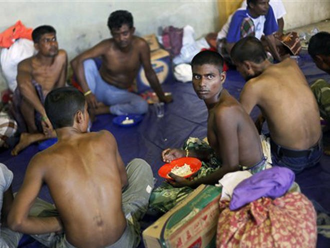 Bangladeshi migrants have their lunch at a temporary shelter for the migrants whose boats washed ashore on Sumatra island on Sunday, in Lhoksukon, Aceh province, Indonesia, Wednesday, May 13, 2015. More than 1,600 migrants and refugees have landed on the shores of Malaysia and Indonesia in the past week and thousands more are believed to have been abandoned at sea, floating on boats with little or no food after traffickers literally jumped ship fearing a crackdown.