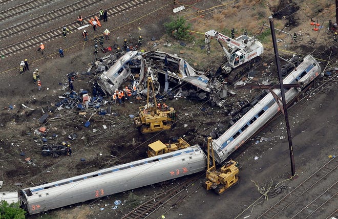 Emergency personnel work at the scene of a deadly train derailment, Wednesday in Philadelphia. The Amtrak train, headed to New York City, derailed and crashed in Philadelphia on Tuesday night, killing at least six people and injuring dozens of others.
