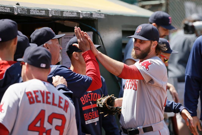 Boston Red Sox starting pitcher Wade Miley is greeted in the dugout during the seventh inning of Wednesday's baseball game against the Oakland Athletics. AP Photo