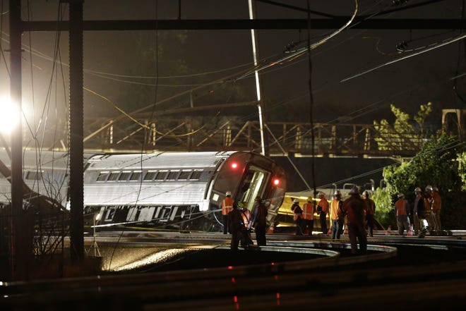 Emergency personnel work the scene of a deadly train wreck, early Wednesday, May 13, 2015, in Philadelphia. An Amtrak train headed to New York City derailed and tipped over in Philadelphia on Tuesday night, mangling the front of it, tearing the cars apart and killing several people. MATT SLOCUM/AP PHOTO