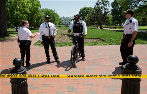 Uniformed Secret Service Police officers stand watch at Lafayette Park near the White House in Washington, Thursday, May 14, 2015, during a lockdown. A federal law enforcement official says a man has been arrested after trying to launch a drone outside the White House fence. (AP Photo/Manuel Balce Ceneta)