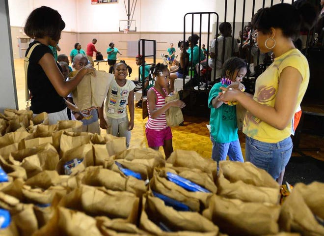 Area children grab a free lunch from the summer lunch program at Thomas N. Lay Community Center on Tuesday, June 4, 2013, in Athens, Ga.  (Richard Hamm/Staff) OnlineAthens / Athens Banner-Herald