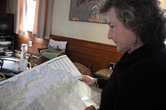 Kathleen Nolan holds a map of Lantang National Park in Nepal and describes the region hit hardest by the April 25 earthquake. Photo by Donna Buttarazzi