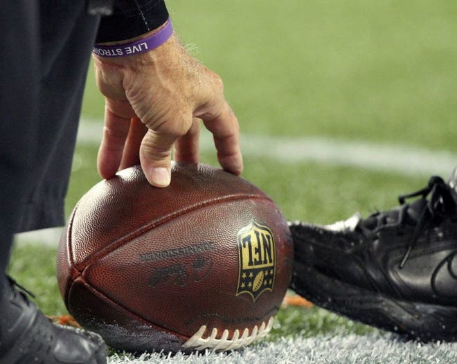 An official spots a ball during the AFC Championship Game, on Jan. 18.