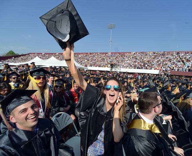 Elizabeth Thomas of Medfield, Mass. reacts to a photographer during graduation ceremonies for the University of Massachusetts Amherst at McGuirk Stadium on campus in Amherst, Mass. on Friday, May 8, 2015. DON TREEGER/AP PHOTO