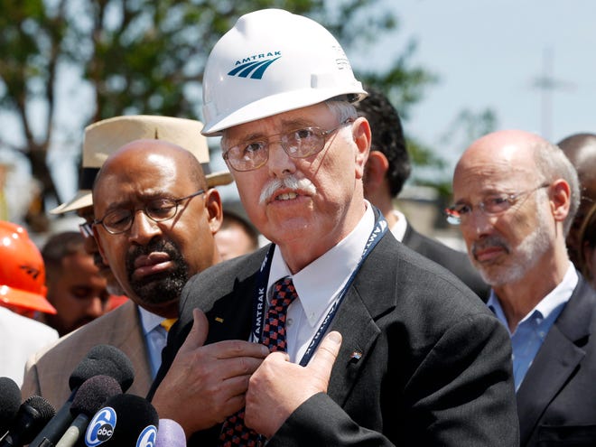 Philadelphia Mayor Michael Nutter, left, and Pennsylvania Gov. Tom Wolf, right, listen as Amtrak CEO, Joseph Boardman expresses his sorrow near the site of a deadly train derailment Thursday in Philadelphia.