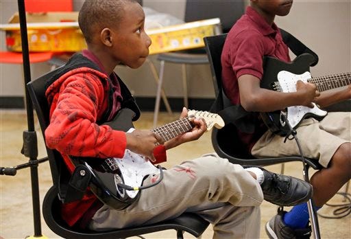 In this photo taken May 6, 2015, a fifth-grade student learns basic blues cords while developing a rudimentary blues song after about 45 minutes, complete with improvised lyrics about how their teacher was so cool that they wanted to buy him a chocolate bar in the B.B. King Museum Learning Center in Indianola, Miss. King died Thursday night, May 14, 2015, at age 89 in Las Vegas, where he had been in hospice care. (AP Photo/Rogelio V. Solis)
