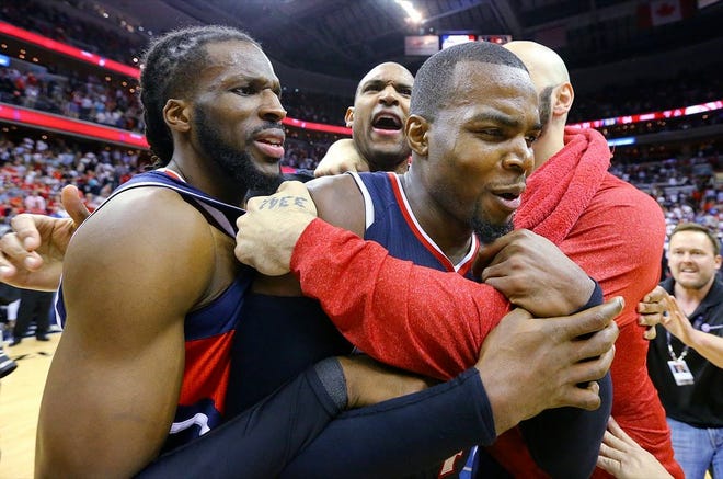 Hawks teammates, from left, DeMarre Carroll, Al Horford, Paul Millsap and Pero Antic celebrate after beating the Wizards 94-91 in Game 6 of the second round in Washington. The win sent the Hawks to the Eastern Conference finals.