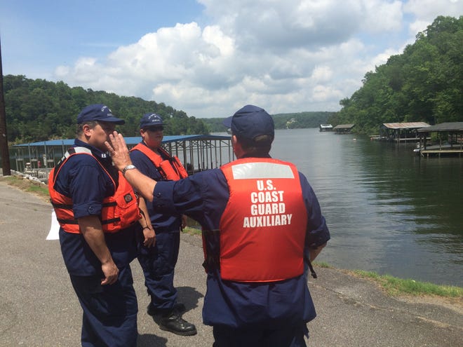Members of the Coast Guard Auxiliary’s West Alabama Flotilla discuss boating safety at Lake Tuscaloosa on Friday. National Safe Boating Week starts today and ends May 22.