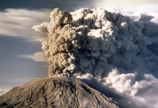 FILE - In this April 1980 file photo, Mount St. Helens spews smoke, soot and ash into the sky in Washington state following a major eruption on May 18, 1980. May 18, 2015 is the 35th anniversary of the eruption that killed more than 50 people and blasted more than 1,300 feet off the mountain's peak. (AP Photo/Jack Smith, file)