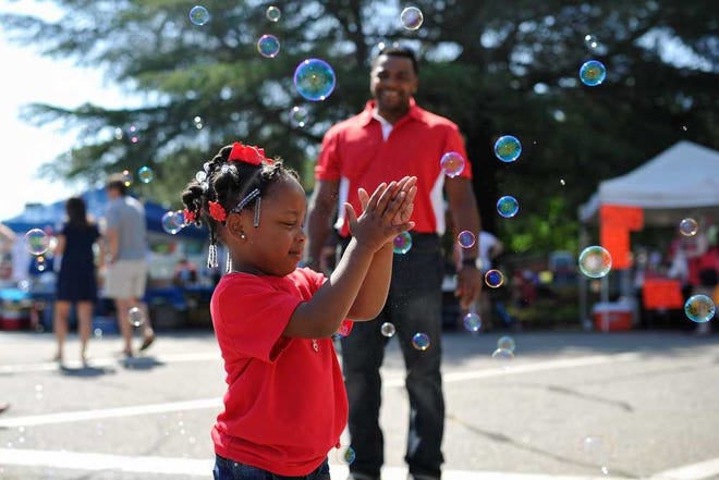 MacKenzie Daniels plays with bubbles in the air at the Marigold Festival on Saturday, May 16, 2015, in Winterville, Ga. (AJ Reynolds/Staff, @ajreynoldsphoto)