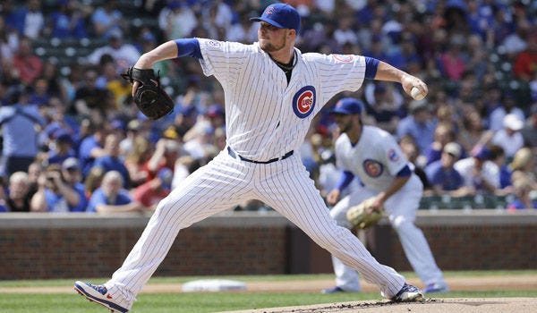 Cubs starter Jon Lester throws a pitch against the Pirates during the first inning on Saturday in Chicago. Lester pitched seven innings, giving up one run on nine hits to earn his fourth victory of the season.