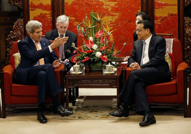 U.S. SECRETARY OF STATE JOHN KERRY, left, talks with Chinese Premier Li Keqiang at the Zhongnanhai Leadership Compound in Beijing on Saturday. Kerry is in China to press Beijing to halt increasingly assertive actions it is taking in the South China Sea that have alarmed the United States and China's smaller neighbors.