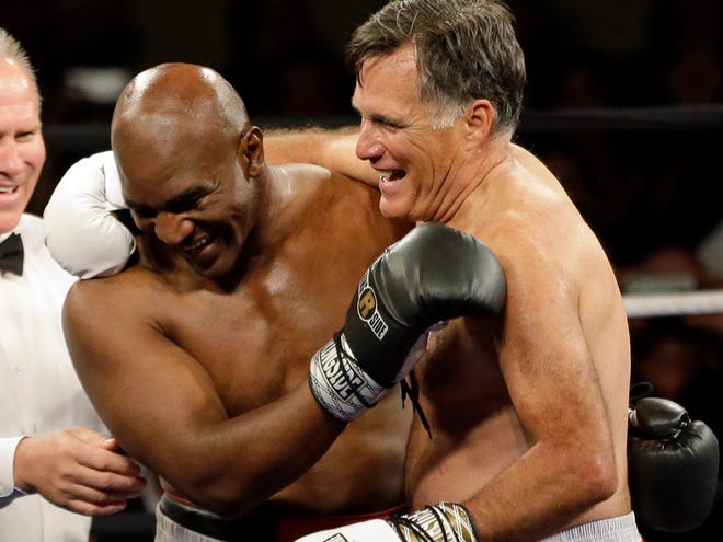 Former Republican presidential candidate Mitt Romney and five-time heavyweight boxing champion Evander Holyfield celebrate after sparring during a charity fight night event Friday, May 15, 2015, in Salt Lake City. The black-tie event will raise money for the Utah-based organization CharityVision, which helps doctors in developing countries perform surgeries to restore vision in people with curable blindness.