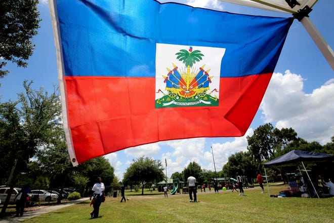 A Haitian flag waves in a tent during the Haitian Youth Association of Polk County's 4th annual Haitian Flag Day Festival at Westwood Park in Winter Haven on Saturday. The event was held to promote the Haitian culture while celebrating the creation of the flag.