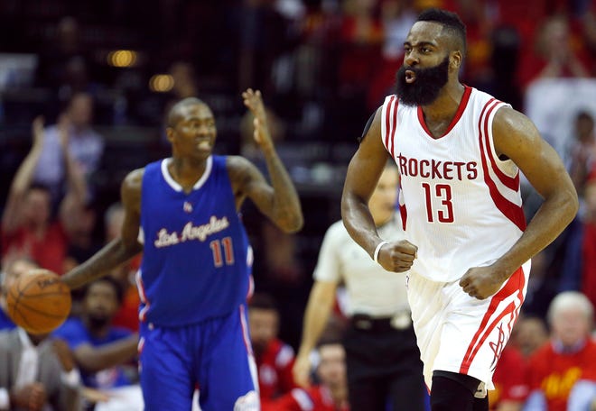 Houston guard James Harden reacts to scoring Sunday as Los Angeles guard Jamal Crawford brings the ball up the court during Game 7 of the Western Conference semifinals in Houston. THE ASSOCIATED PRESS