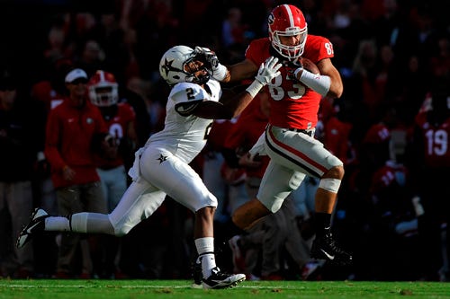 Georgia tight end Jeb Blazevich (83) attempts to break a tackle from Vanderbilt defensive back Tre Tarpley (2) after catching a pass from Georgia running back Todd Gurley (3) during an NCAA college football game between Georgia and Vanderbilt on Saturday, Oct. 4, 2014, in Athens, Ga.